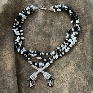 Rod’s black and white rock chunky necklace. With removable double pistol charm